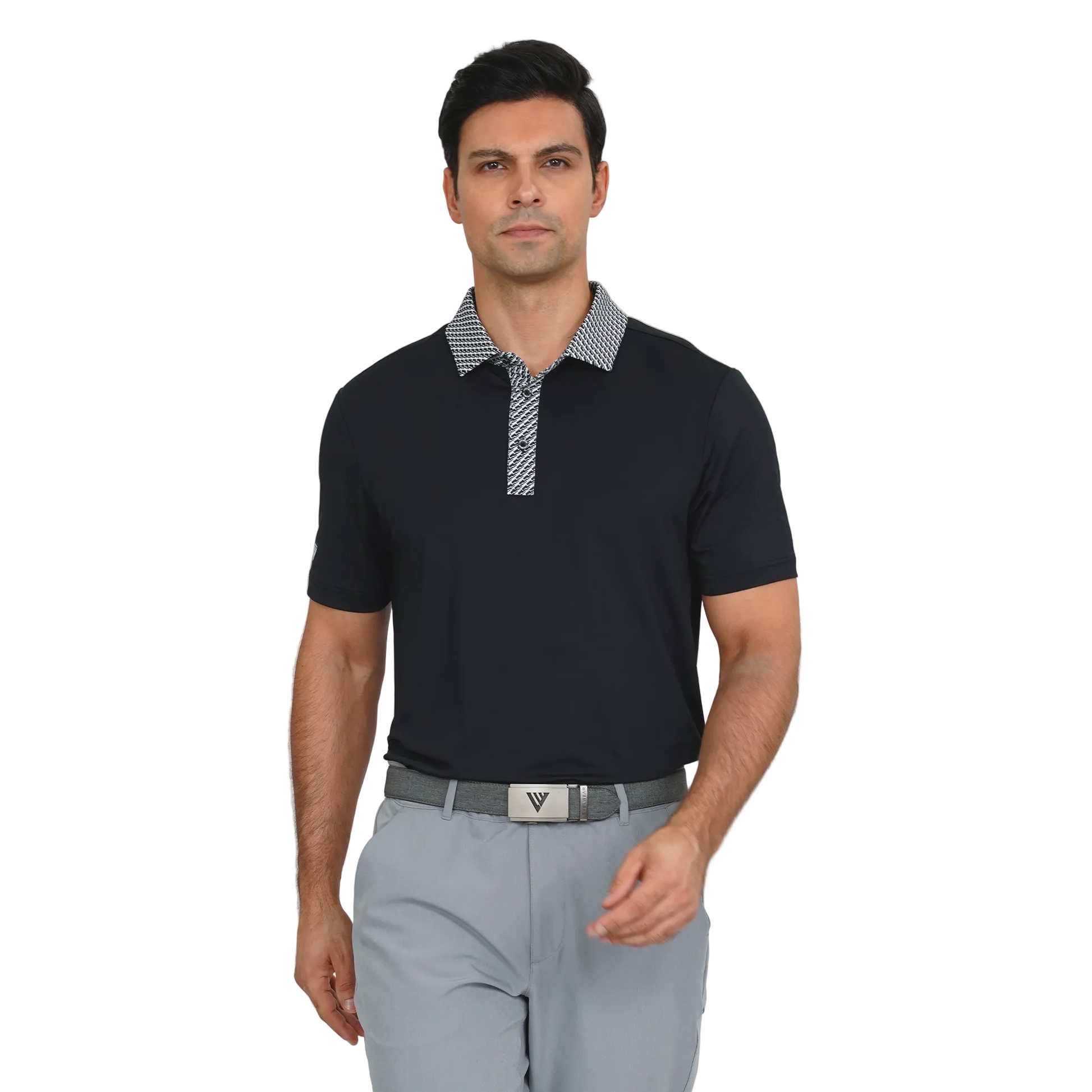 Man wearing a Levelwear black polo shirt with a patterned collar and gray pants on a light gray background