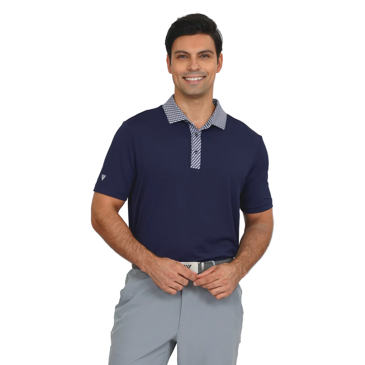 Man wearing a Levelwear navy blue polo shirt with a checkered collar and gray pants on a light gray background