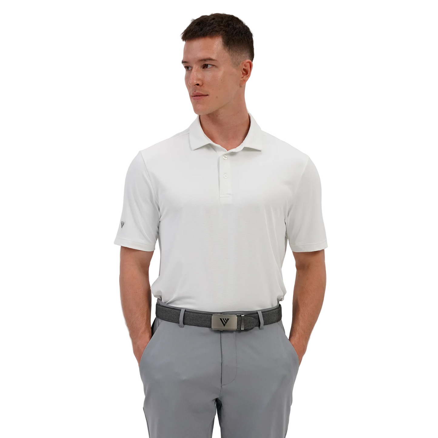 Man wearing a Levelwear white polo shirt and gray pants on a light gray background